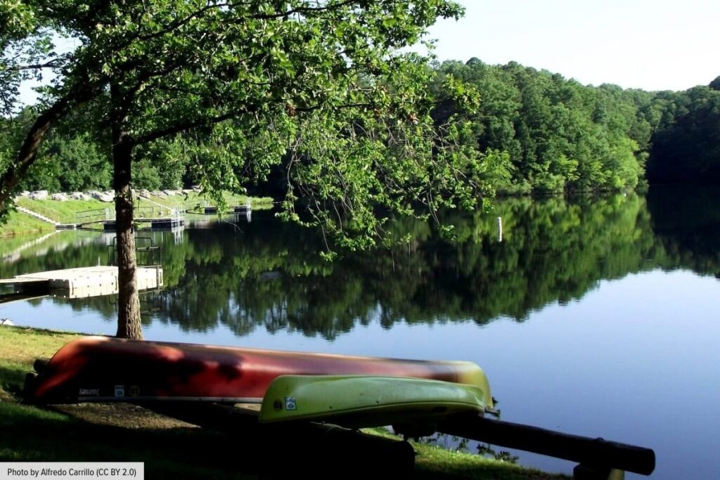 Calm Lake View With Canoe On Shoreline In Bella Vista Arkansas