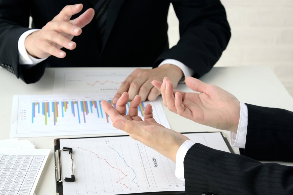 Business handshake agreement over documents