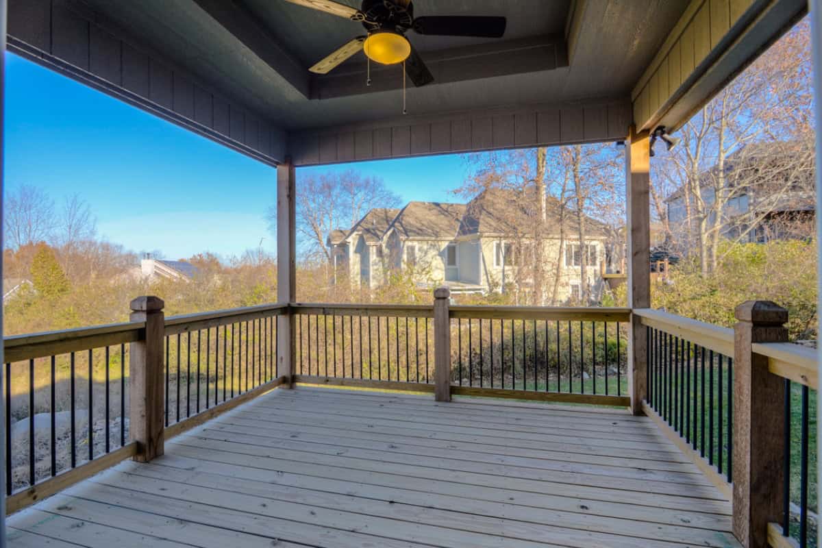 Covered Outdoor Deck Overlooking Backyard