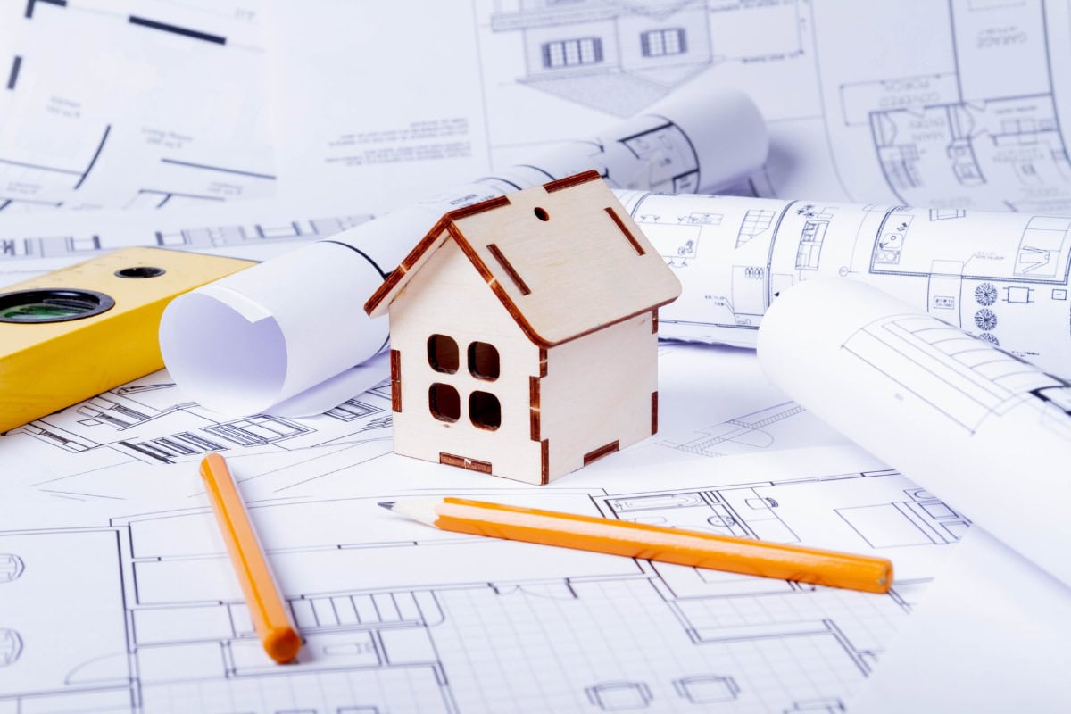 Custom home planning with blueprints and house model