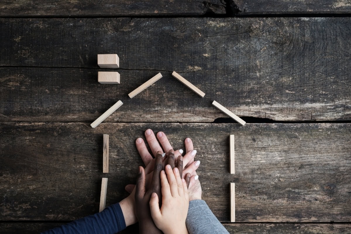 Home layout planning with hands and house outline