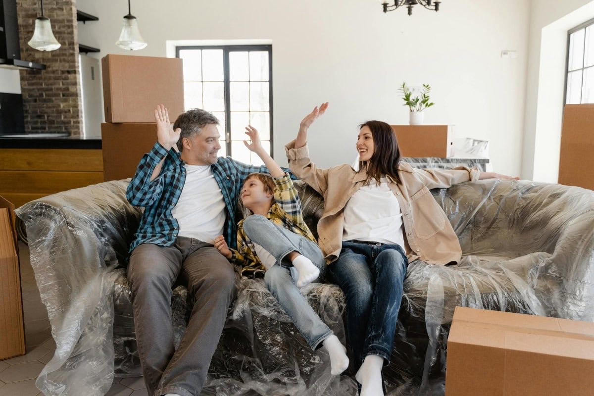 Family sitting together on couch in Northwest Arkansas home