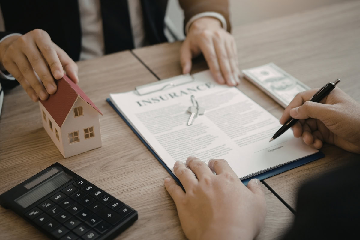 Signing home contract documents with calculator