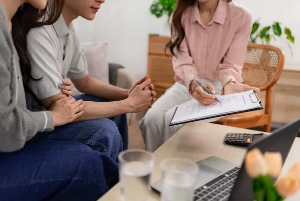 Home Design Consultation With Builder Reviewing Plans