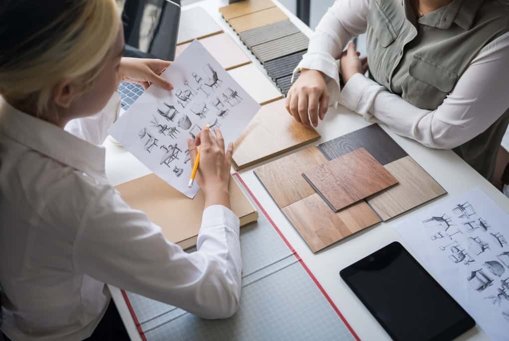 Homeowners Reviewing Design Plans And Material Selections